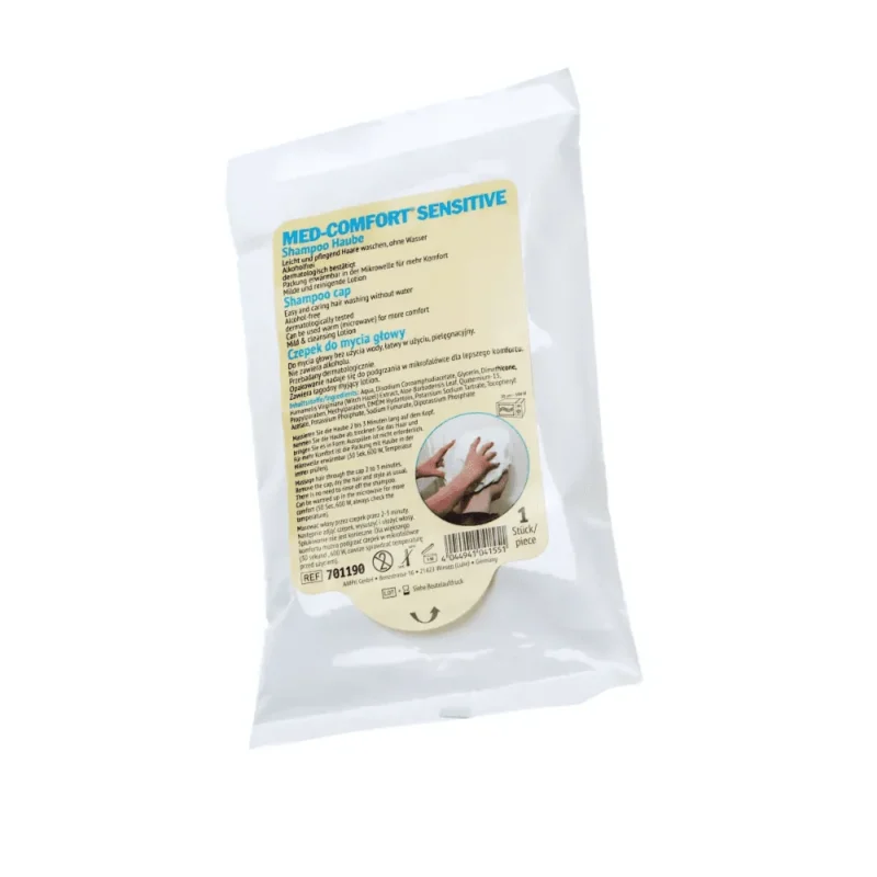 Eine weiße Kunststoffverpackung mit der Aufschrift „Med-Comfort Shampoohaube mit pflegendem Conditioner“ der AMPri Handelsgesellschaft mbH. Auf der Vorderseite finden Sie Anweisungen und Details in mehreren Sprachen. Ideal für die Pflege von bettlägerigen Menschen, enthält es eine Einmal-Med-Comfort-Shampoohaube, die eine hygienische Haarwäsche gewährleistet. Der Hintergrund ist weiß.