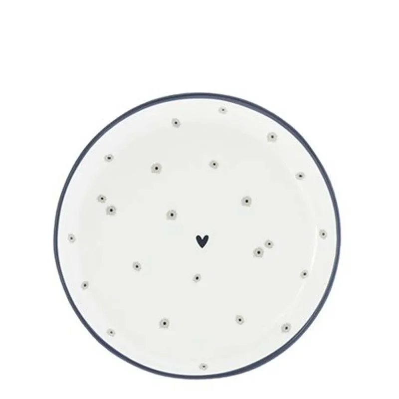 Ein weißer Bastion Collections – Teller Mini Daisies Teller mit schwarzen Punkten darauf.